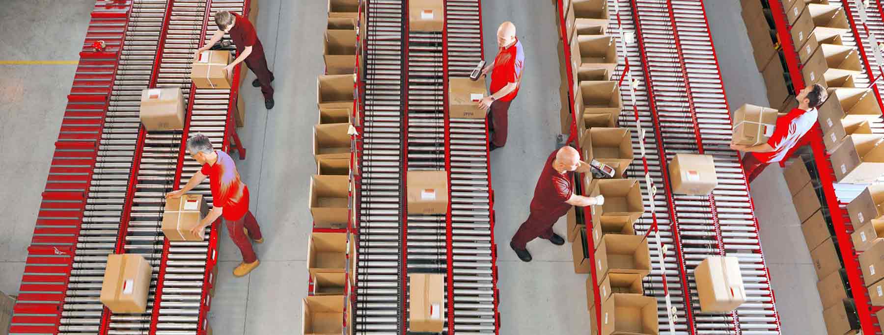 workers pick orders at automated warehouse using conveyors